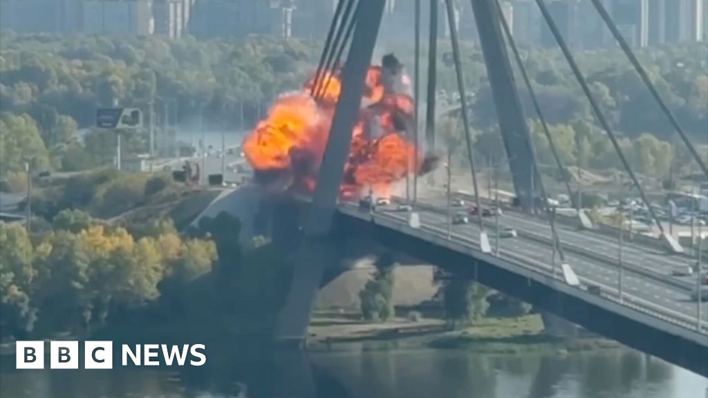 Kyiv bridge hit in further Russian drone attack as German chancellor makes surprise visit